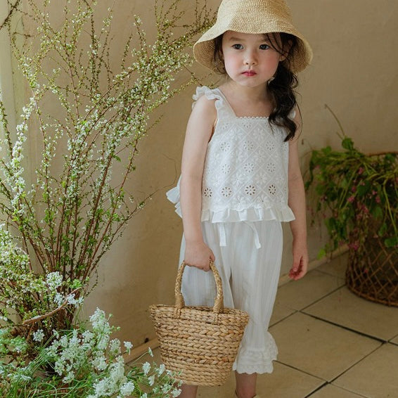 The adorable lace camisole features a charming pattern in soft cotton, with cute chest lace and frill hem details. Paired perfectly with Flo Laurent pants - soft cotton with lace hem and ribbon waist accents. A sweet matching set for everyday or special occasions.